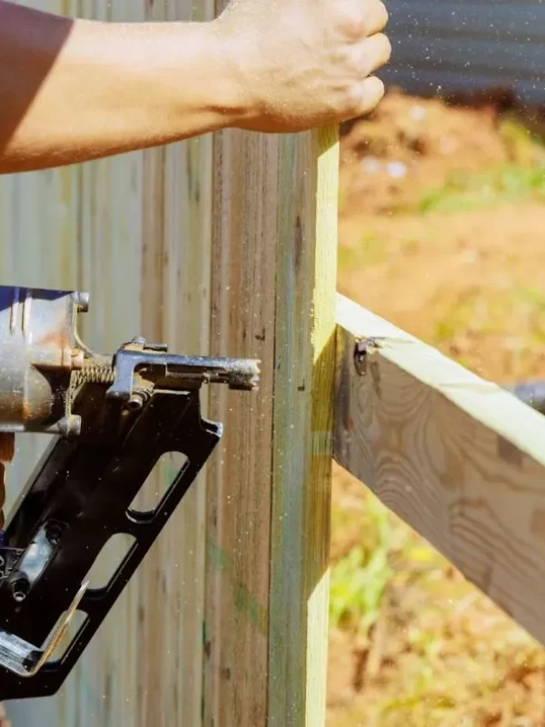 Man installing wood fencing.