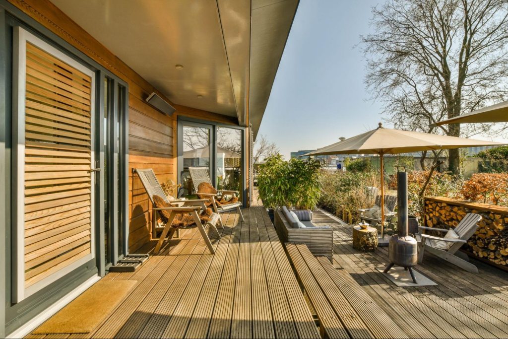 Patio made out of wood with outdoor furniture.