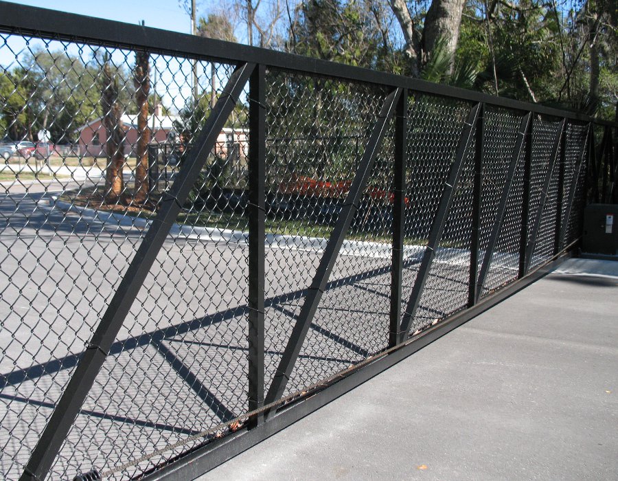 A black chain link fence installed on a street, providing security and boundary.