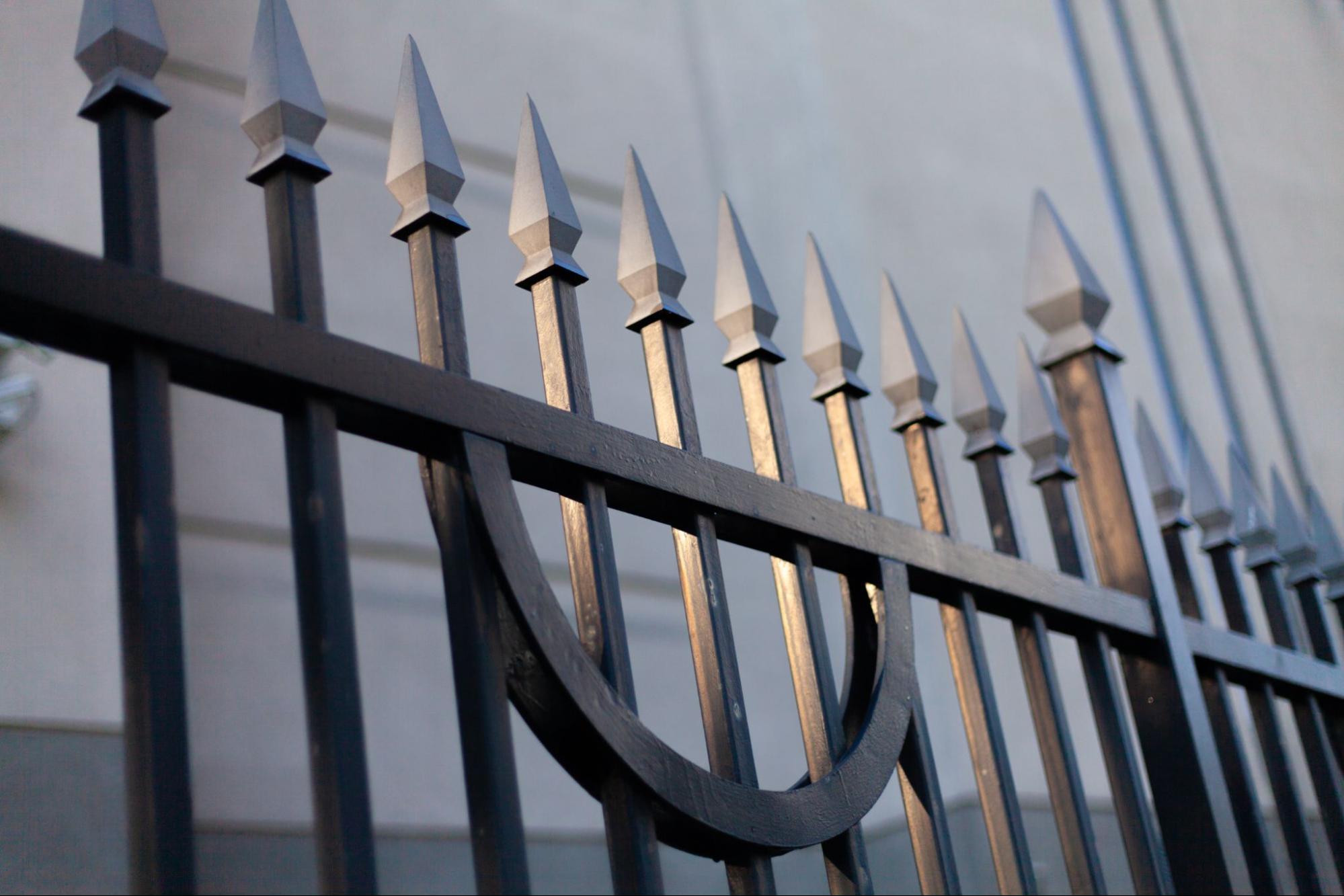 A close-up shot of sharp spikes on a steel gate, highlighting their detail and texture.