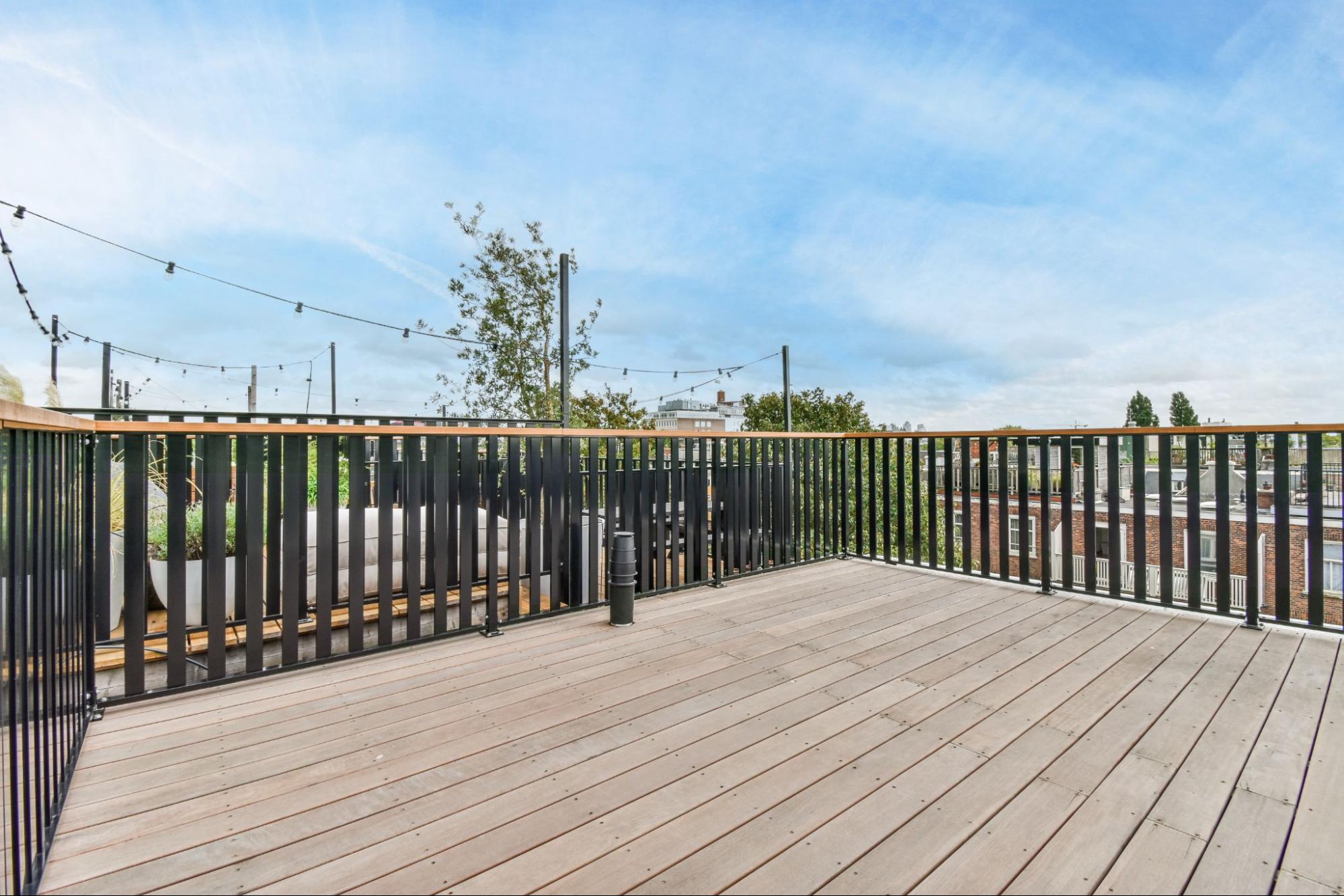 A rooftop terrace with secured railings.