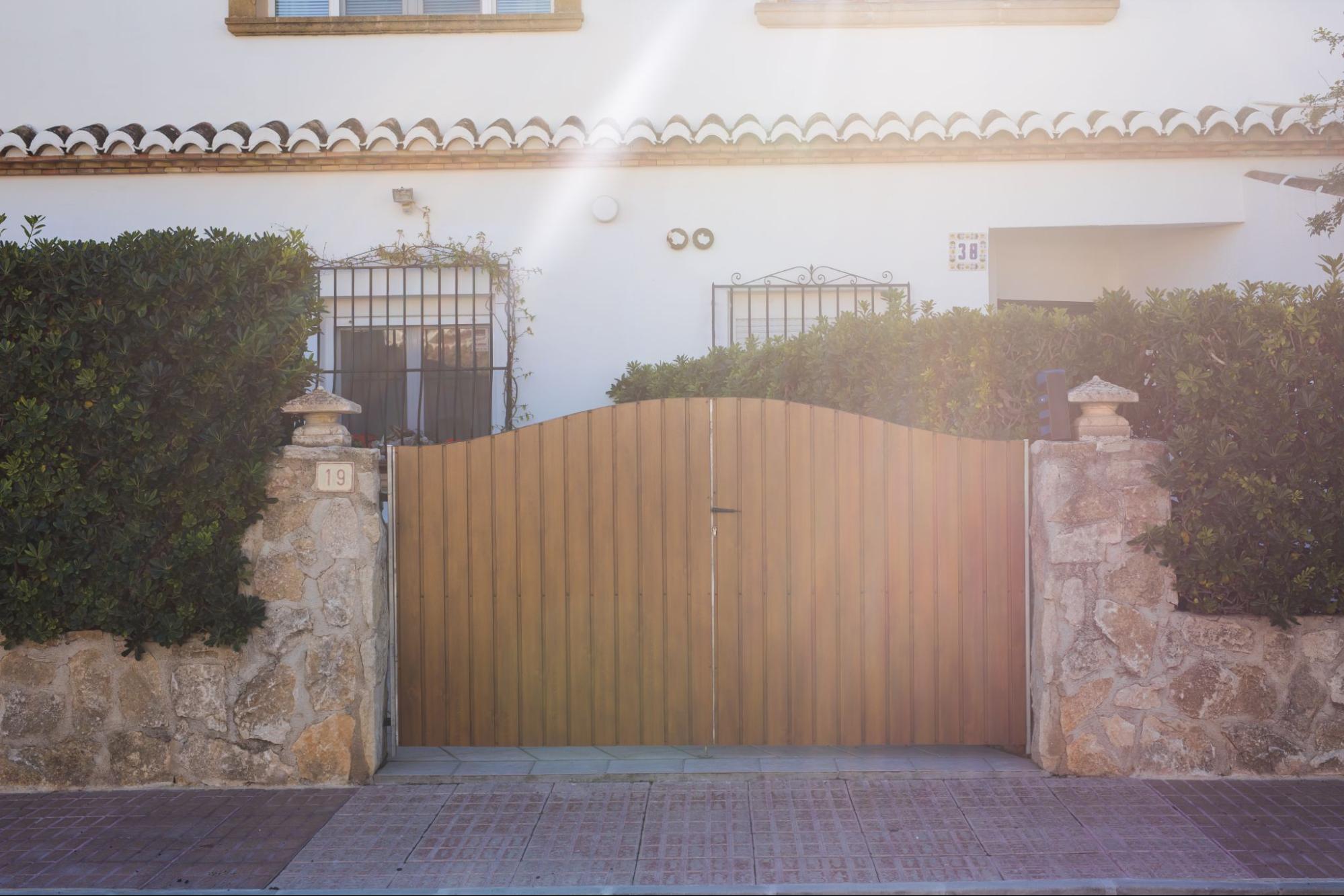 Wooden gate in-front of a home.