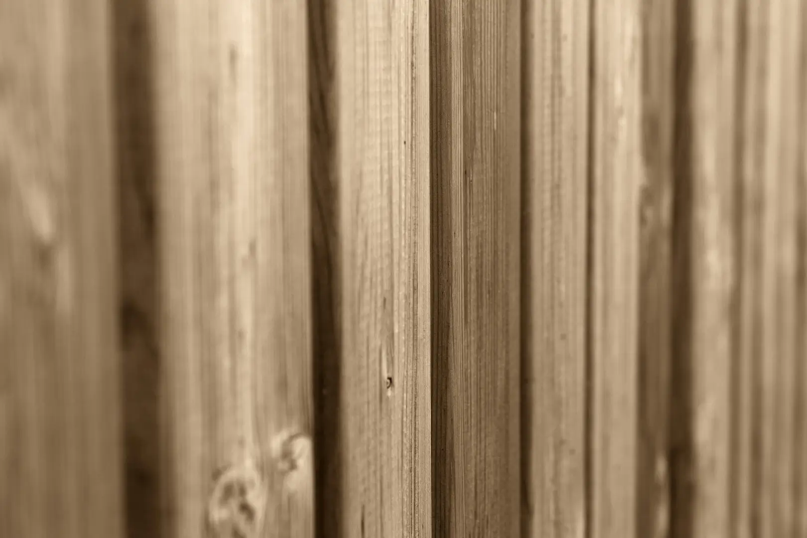 A close-up image of a wood grain vinyl fence.