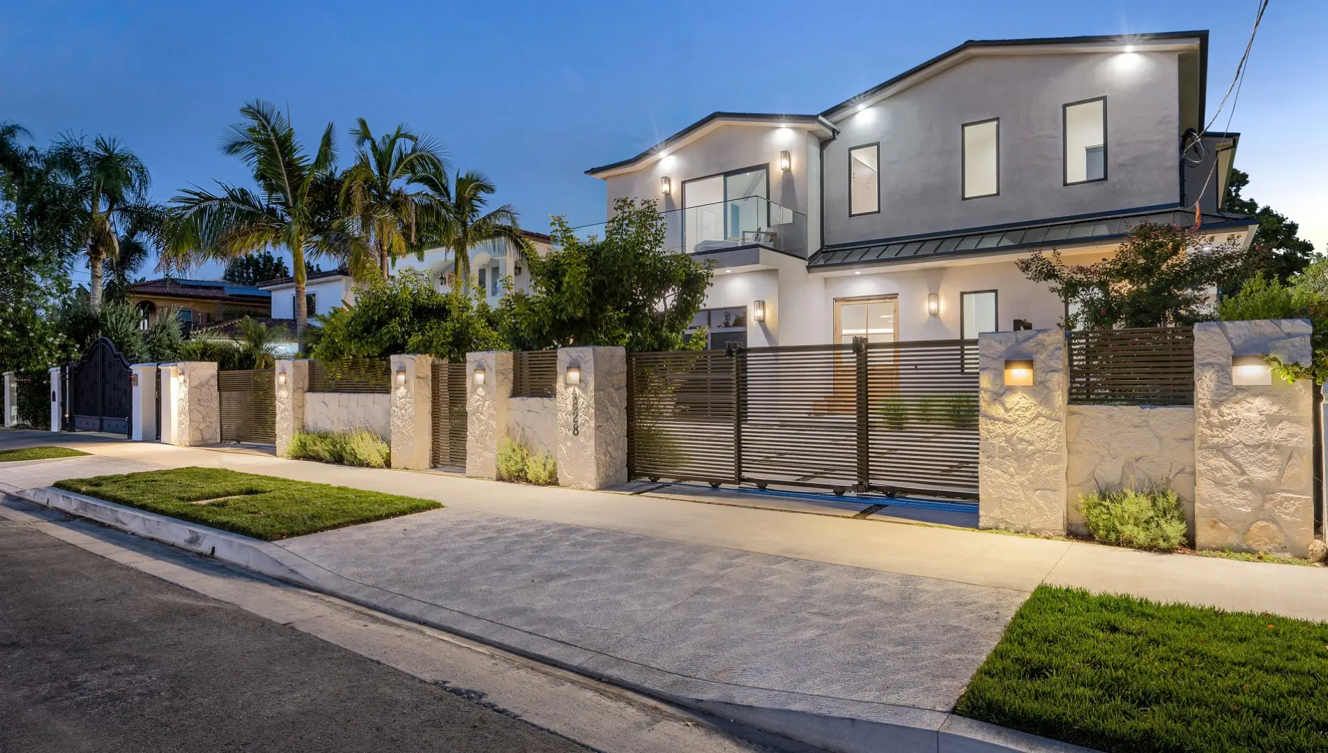 A front view of a modern home with fenced entrance.