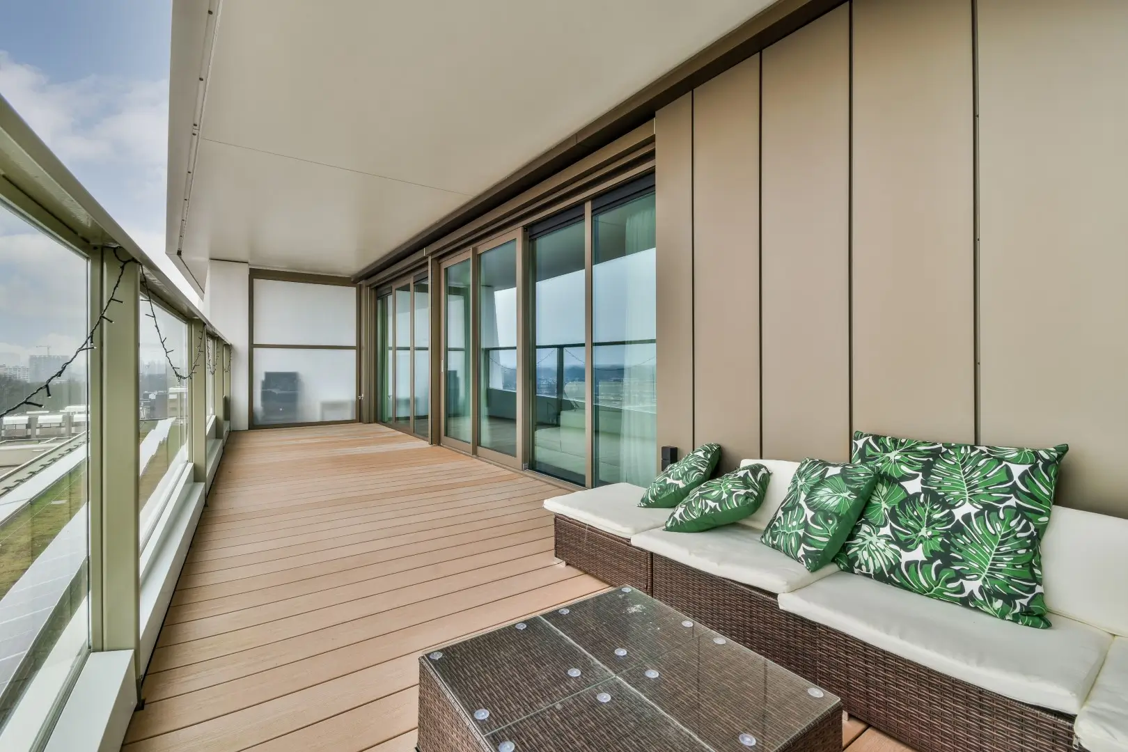 A large balcony with a wooden floor.