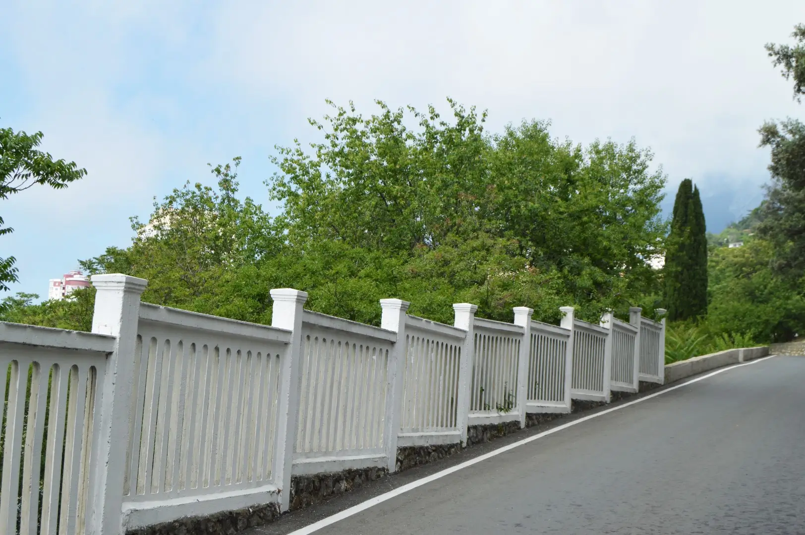 A white wood grain vinyl fence surrounding the perimeter of a property.