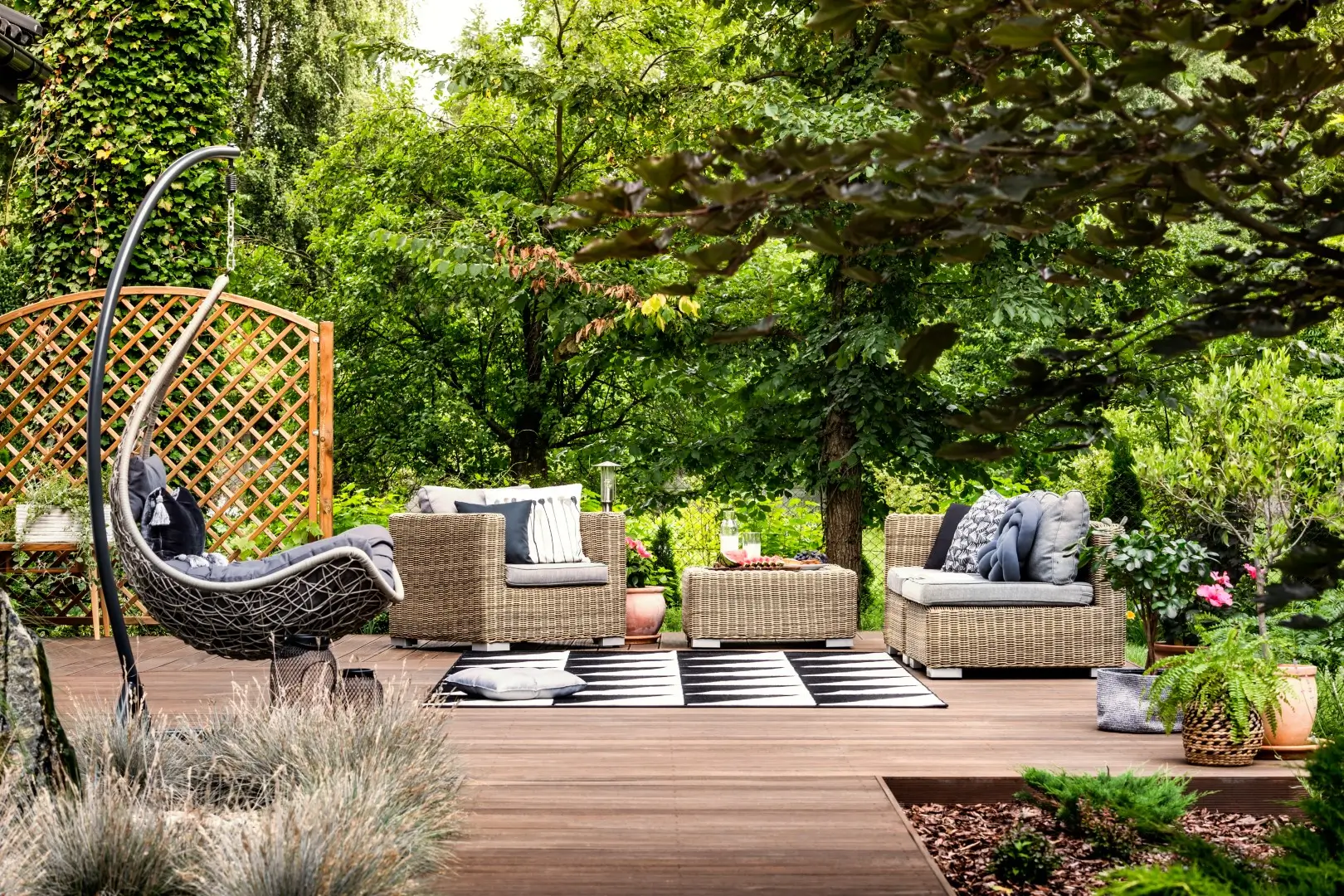 Elegant garden furniture arranged on a spacious terrace with a high-quality deck installation.