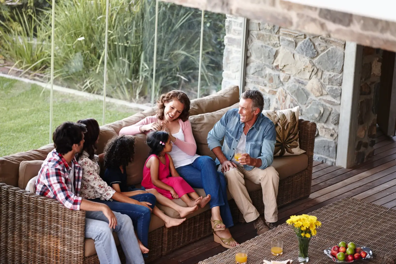 Family gathered near a covered patio seating area.