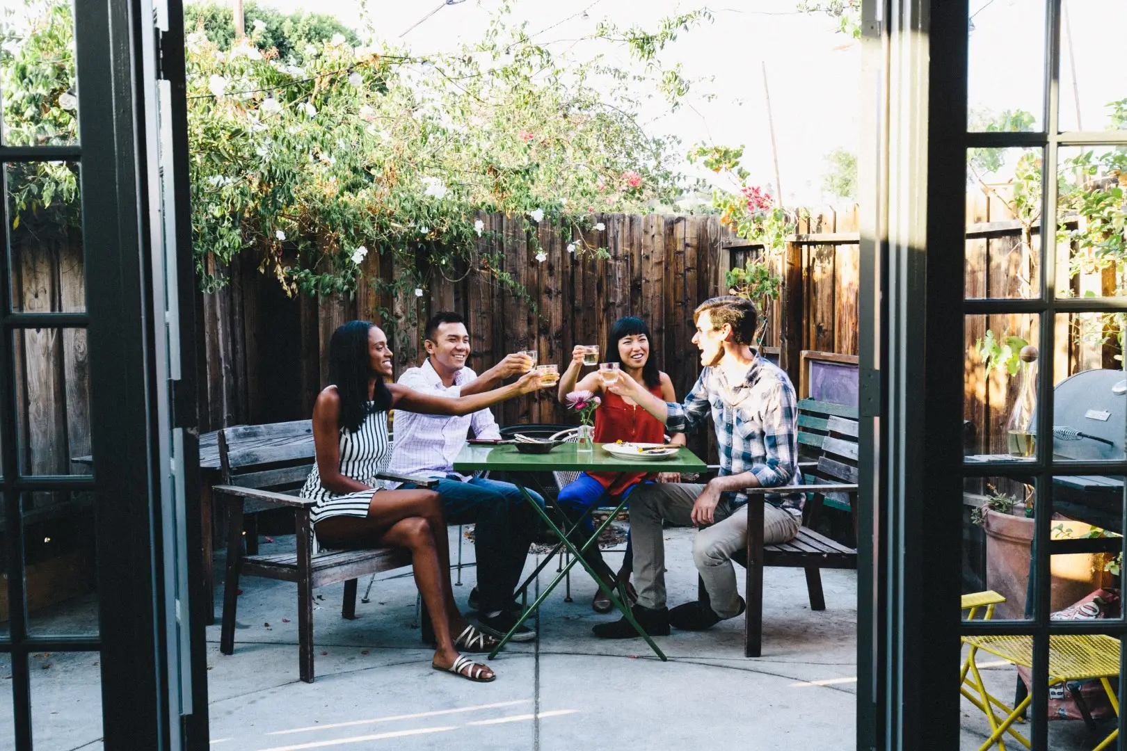 Four friends sharing stories on the patio.