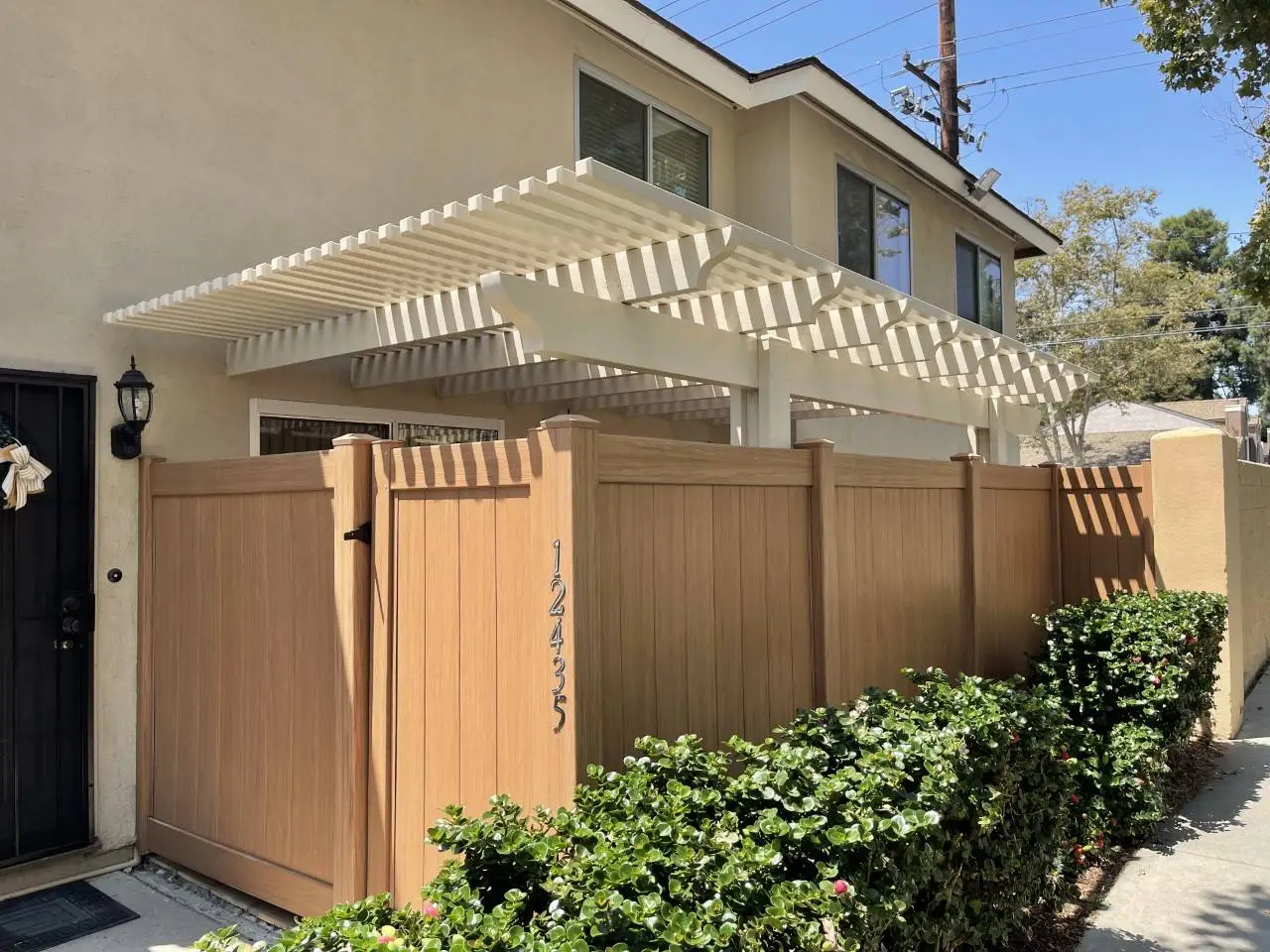 Beige house with wooden fence gate