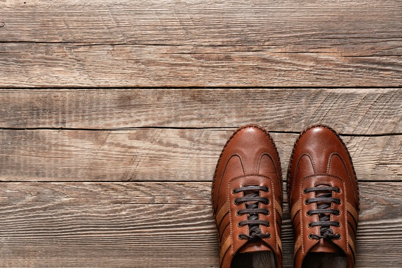Shoes on a textured wooden floor.