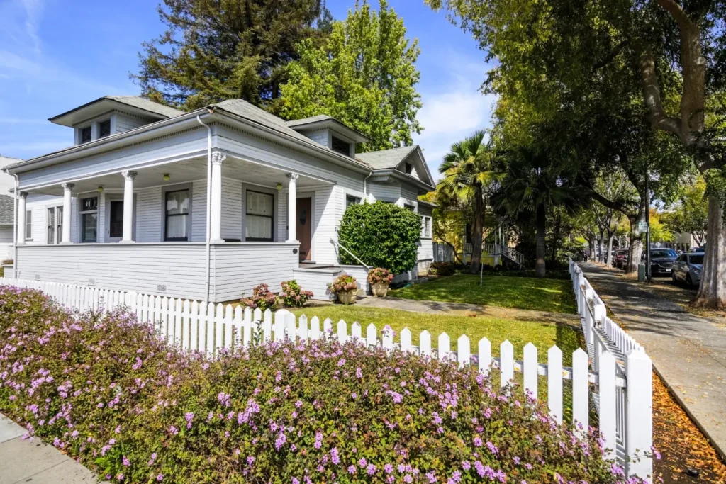 White vinyl fences on the green lawn surrounded the property.