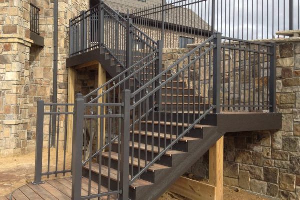 A metal stairway with a railing and steps, providing safe access between different levels.