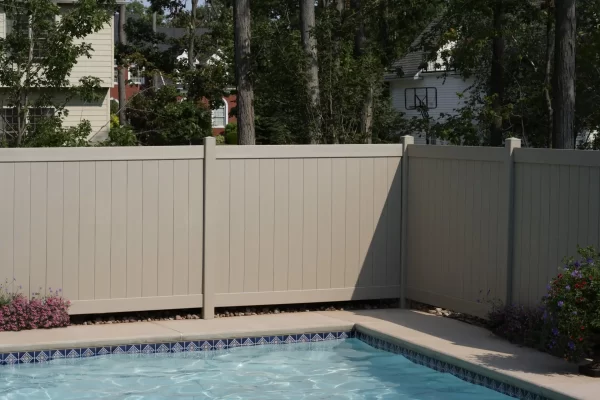 Beige fence with swimming pool.