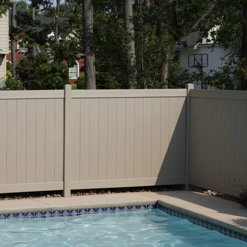 Beige fence with swimming pool.
