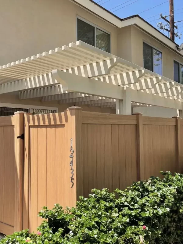 Beige house with wooden fence gate