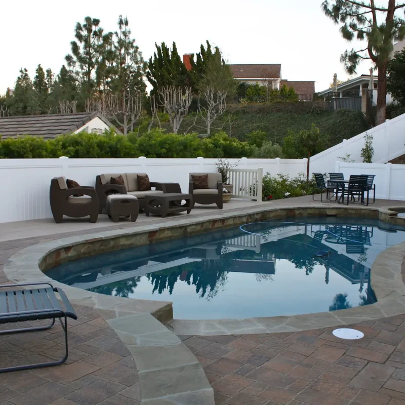 Beautiful backyard with fence and pool.