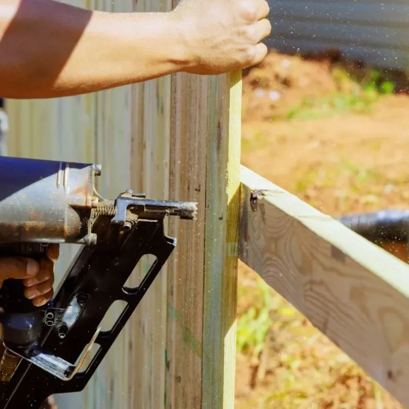 Man installing wood fencing.