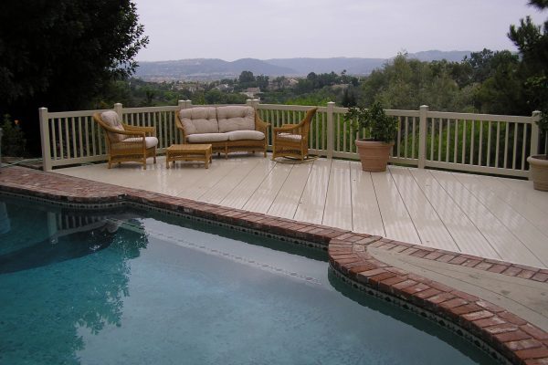 Deck with railing and a swimming pool