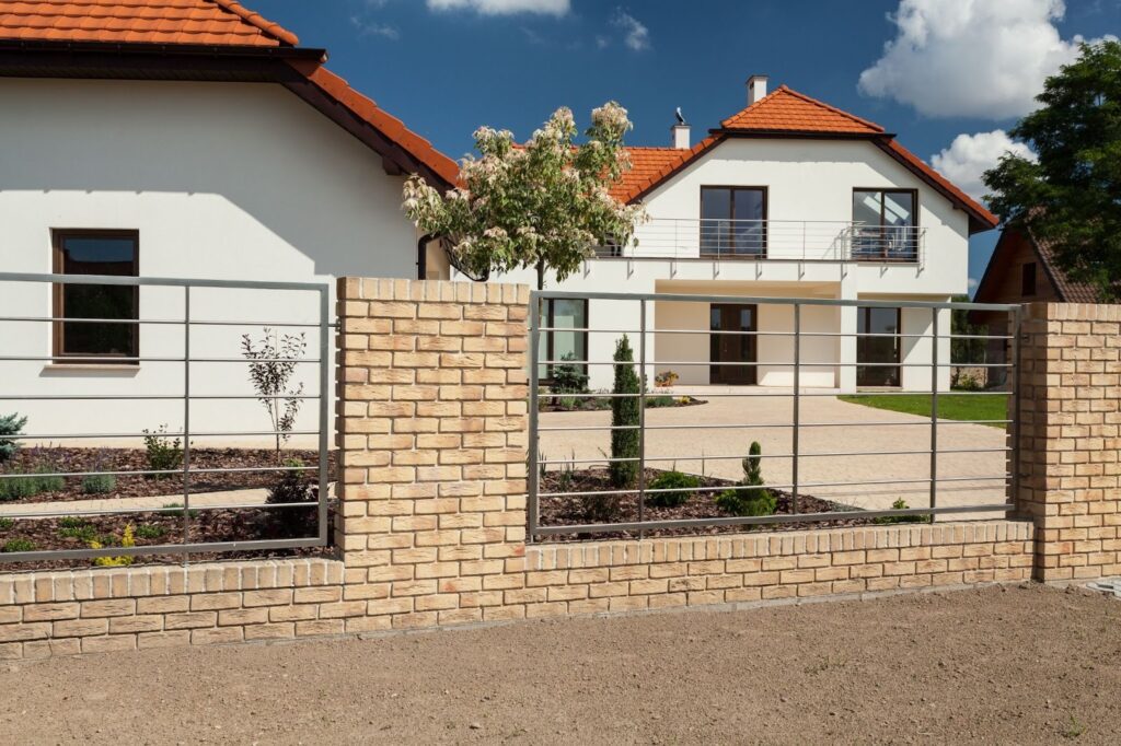 Modern suburban home featuring a sleek aluminum fence