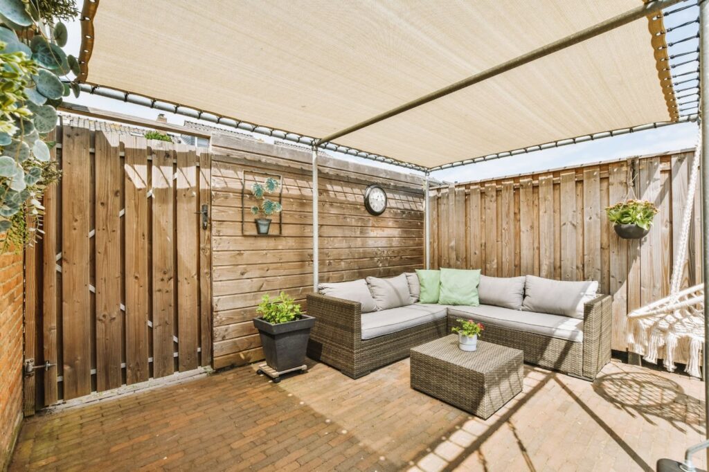 Neat outdoor covered patio with cozy sitting area and canvas cover