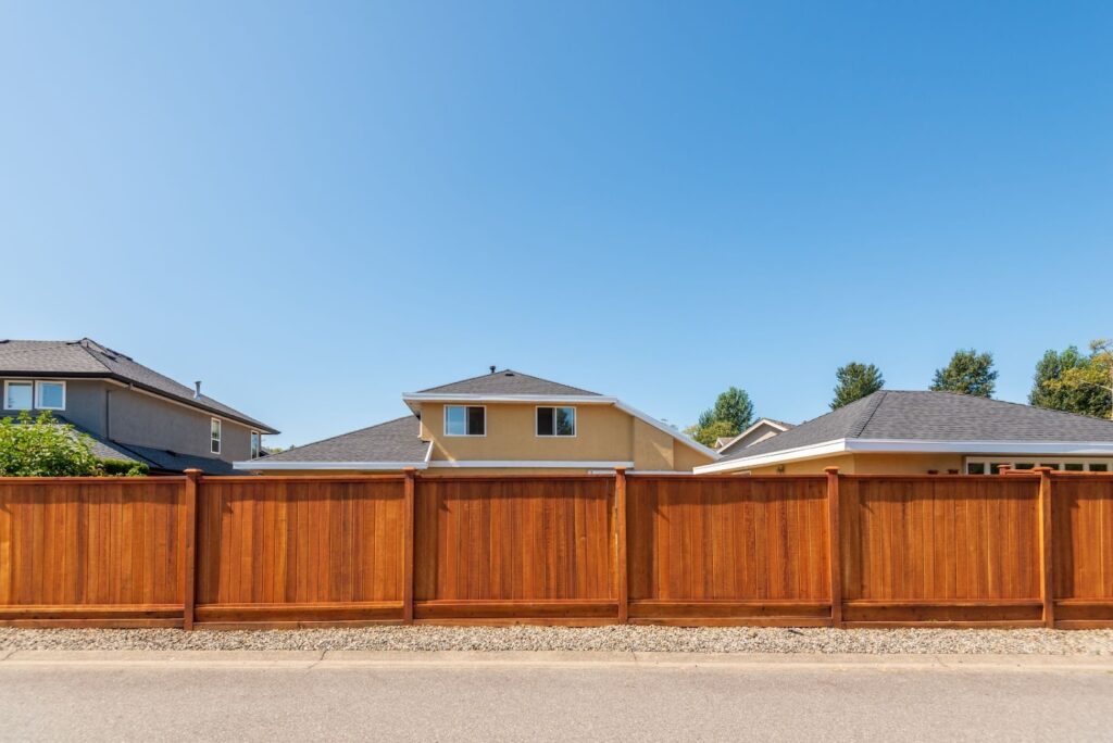 Vinyl fence featuring a wood grain finish that mimics real lumber