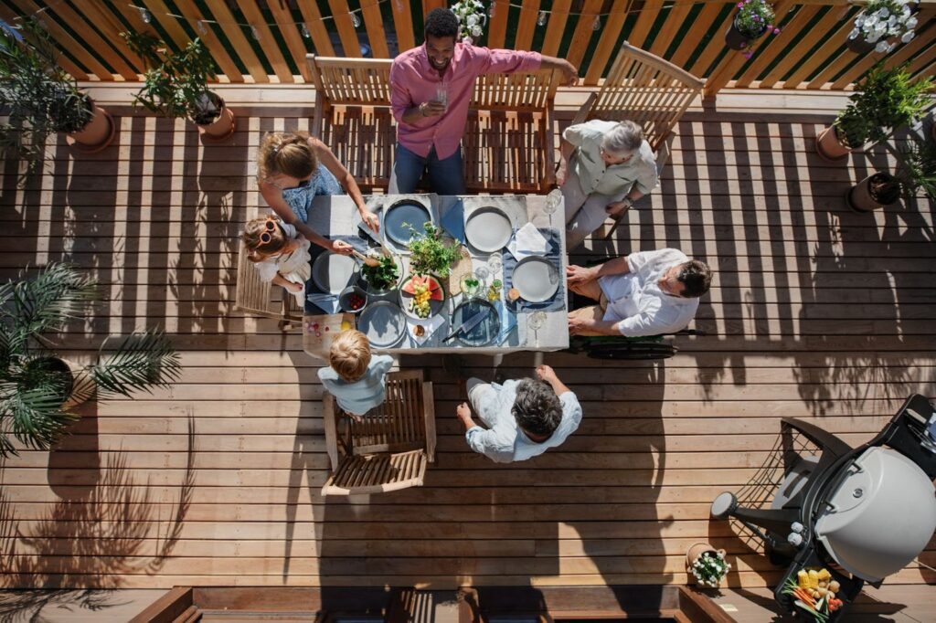 Top-down view of a family sitting on their deck having dinner.