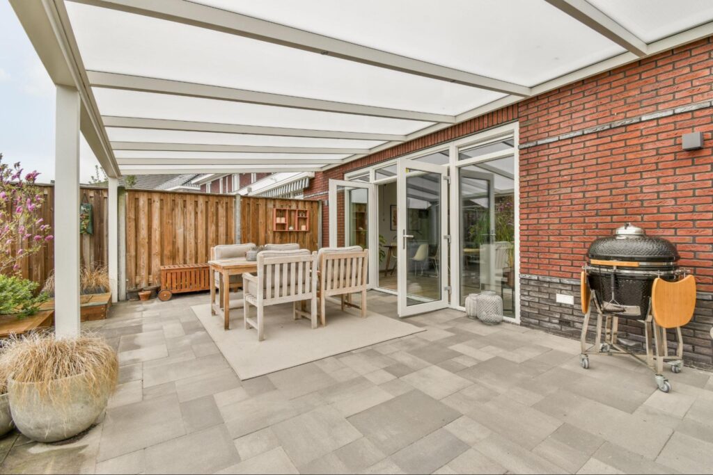 Neat patio with a cozy sitting area and a sturdy patio cover for shade and comfort