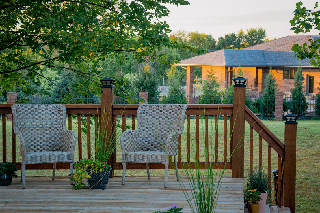 Two chairs on an outdoor deck.