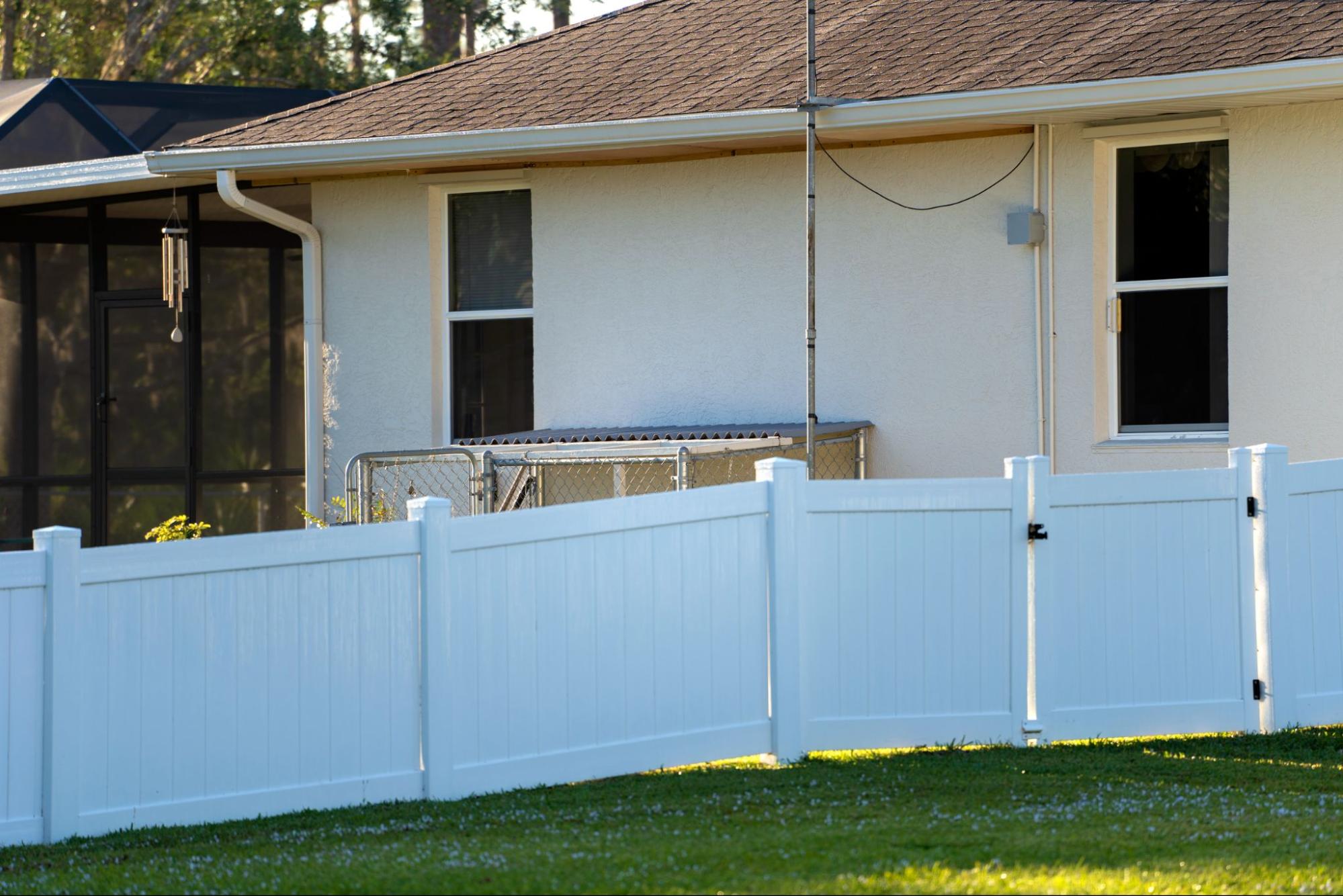 A white vinyl fence encloses the property to deter trespassers.